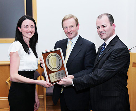 The Taoiseach presenting an Excellence Award to our team 